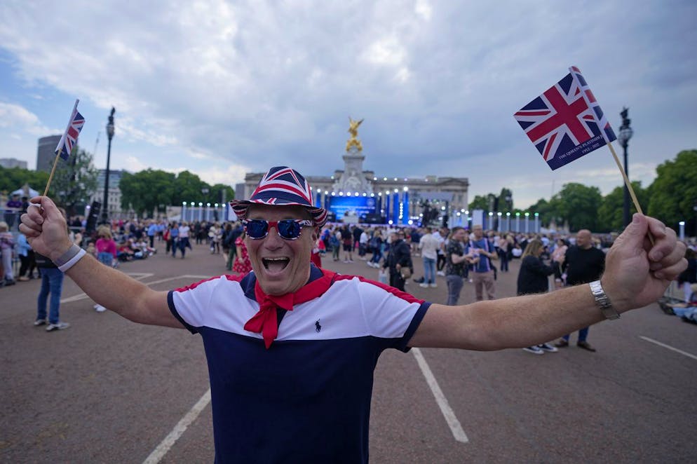 A Royal fan as he stands on the Mall near Buckingham Palace, London, Saturday June 4, 2022 ahead of the Platinum Jubilee concert, on the third of four days of celebrations to mark the Platinum Jubilee. The events over a long holiday weekend in the U.K. are meant to celebrate Queen Elizabeth II's 70 years of service. (AP Photo/Frank Augstein)