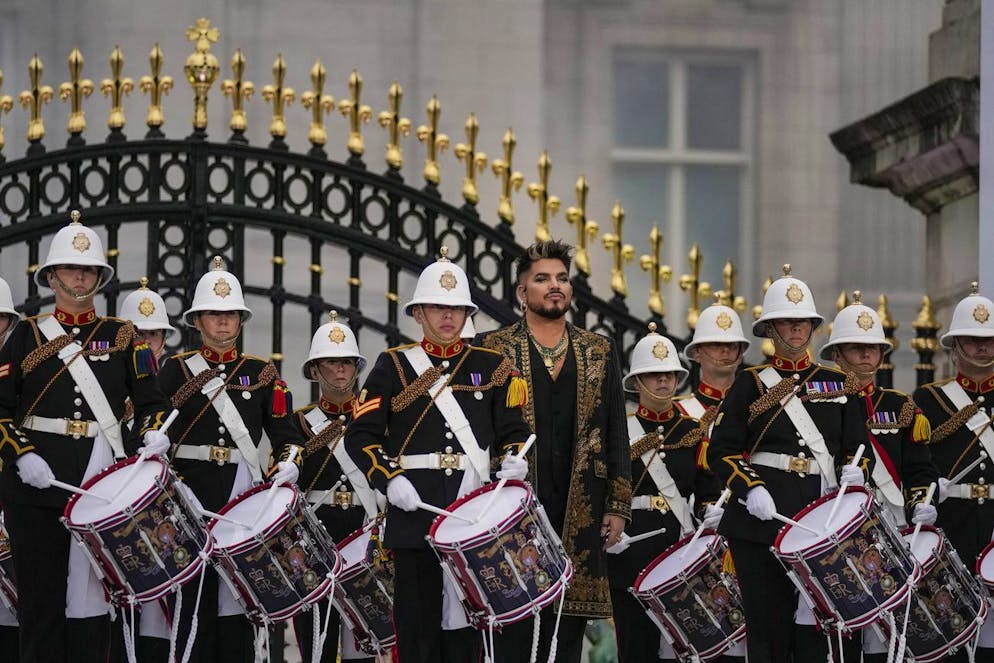 Adam Lambert, center, from the band Queen performs with the Royal Marine drummers at the Platinum Jubilee concert taking place in front of Buckingham Palace, London, Saturday June 4, 2022, on the third of four days of celebrations to mark the Platinum Jubilee. The events over a long holiday weekend in the U.K. are meant to celebrate Queen Elizabeth II's 70 years of service. (AP Photo/Alastair Grant, Pool)