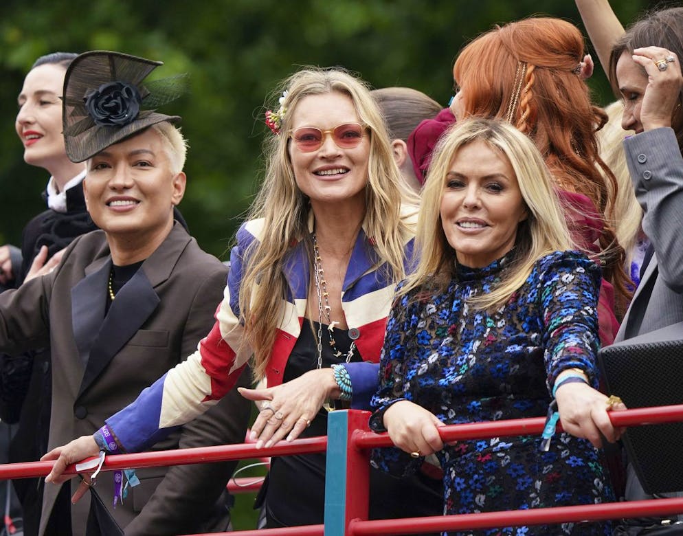 Kate Moss, center, and Patsy Kensit take part in the Platinum Jubilee Pageant in front of Buckingham Palace, in London, Sunday June 5, 2022, on the last of four days of celebrations to mark the Platinum Jubilee. The pageant will be a carnival procession up The Mall featuring giant puppets and celebrities that will depict key moments from the Queen Elizabeth IIâÄ™s seven decades on the throne. (Yui Mok/PA via AP)