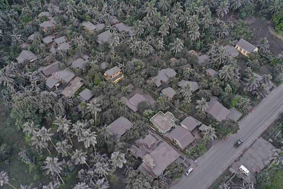 Une photo prise avec un drone et mise à disposition par le Bureau provincial d'information de Sorsogon (SPIO) montre un village couvert de cendres volcaniques provenant de l'éruption du volcan Bulusan.