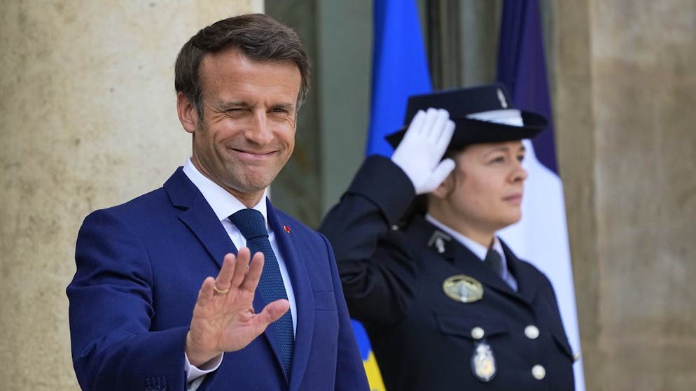FILE - French President Emmanuel Macron greets the media as he awaits European Council President Charles Michel for lunch at the Elysee Palace, Monday May16, 2022. French voters were choosing lawmakers in a parliamentary election Sunday, June 12, 2022 as President Emmanuel Macron seeks to secure his majority while under growing threat from a leftist coalition. (AP Photo/Michel Euler, File)