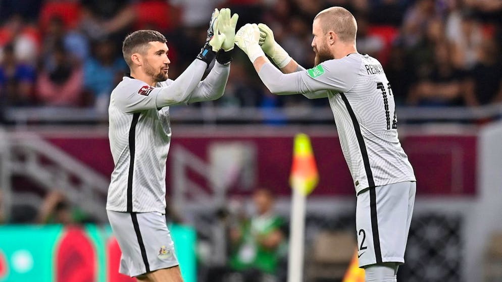 epa10011596 Australia's goalkeeper Mathew Ryan (L) is replaced by teammate Andrew Redmayne (R) for the penalty shootout of the FIFA World Cup 2022 Intercontinental playoff qualifying soccer match between Australia and Peru in Al Rayyan, Qatar, 13 June 2022. EPA/Noushad Thekkayil