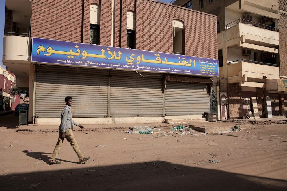 People set up a barricades and close shops as part of a civil disobedience campaign following killing of 7 anti-coup demonstrators in Khartoum, Sudan, Tuesday, Jan.18, 2022. The pro-democracy movement condemned Monday's deadly shootings and called for a two-day civil disobedience campaign over the security forces' actions. (AP Photo)