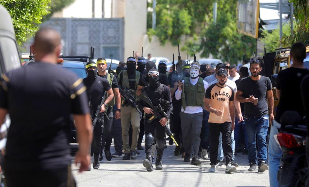 epa10017954 Palestinian militants hold their guns during the funeral of three militants after Israeli troops opened fire and killed three Palestinians in in the West Bank City of Jenin, 17 June 2022. The Israeli army spokesperson said the shooting occurred during a raid conducted to seize illegal weapons and Israeli soldiers responded to Palestinian fire. According to the Palestinian Ministry of Health, 14 other people were wounded during clashes that erupted following the raid. EPA/ALAA BADARNEH