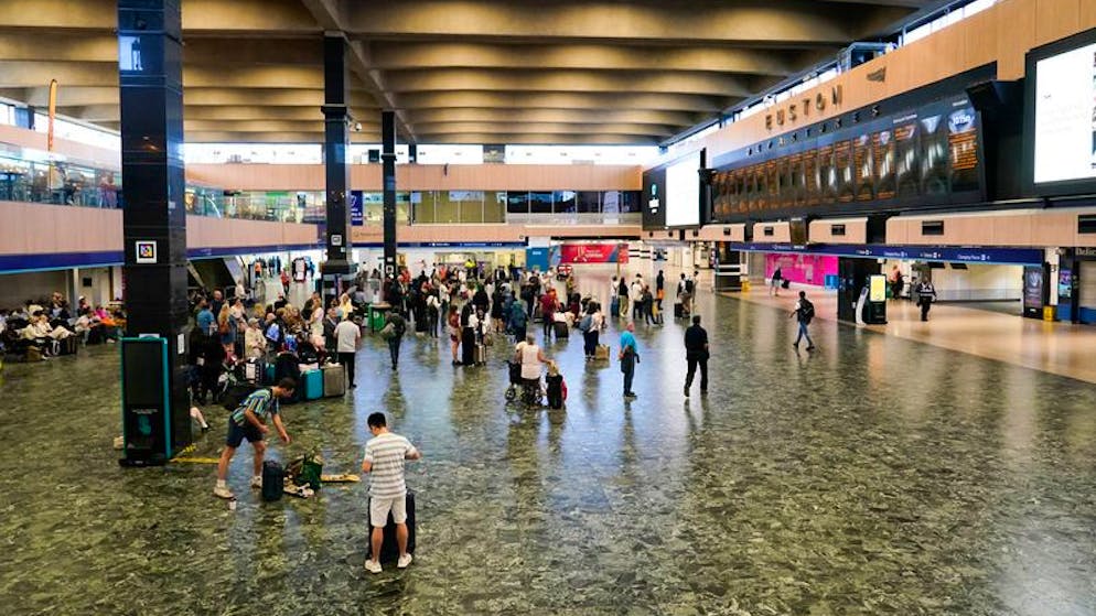 Fahrgäste in einer Halle des Londoner Euston-Bahnhofs. Foto: Alberto Pezzali/AP/dpa