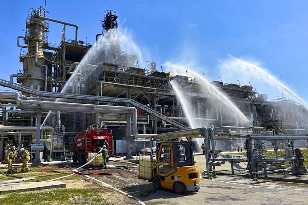 In this handout photo released by Russian Emergency Ministry Press Service, Russian Emergency Situation ministry's firefighters work at the scene of a fire at the Novoshakhtinsk oil processing plant in the Rostov-on-Don region in Russia, Wednesday, June 22, 2022. A drone strike caused a fire at a refinery in southwestern Russia near the border with Ukraine on Wednesday, but no one was hurt and the blaze was contained quickly, officials said. (Russian Emergency Ministry Press Service via AP)