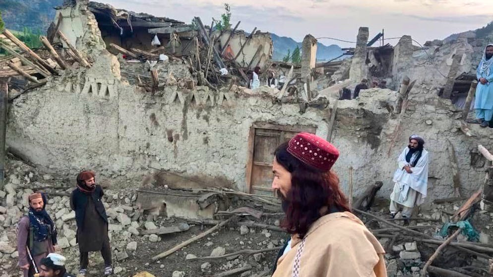 In this photo released by a set-run news agency Bakhtar, Afghans look at destruction caused by an earthquake in the province of Paktika, eastern Afghanistan, Wednesday, June 22, 2022. (Bakhtar News Agency via AP)