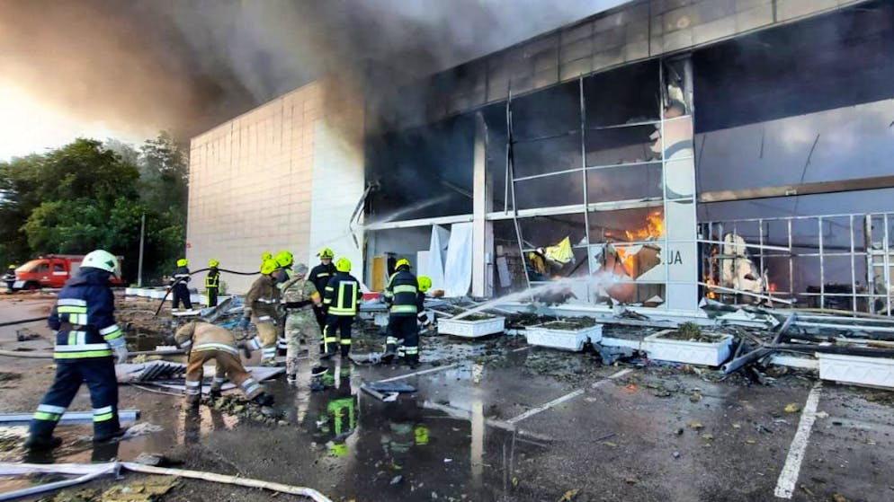 This handout picture taken and released by the Ukraine's State Emergency Service on June 27, 2022 shows firefighters putting out the fire in a mall hit by a Russian missile strike in the eastern Ukrainian city of Kremenchuk, killing at least two and injuring dozens more, Ukraine's President said. (Photo by UKRAINE EMERGENCY MINISTRY PRESS SERVICE / AFP) (Photo by STR/UKRAINE EMERGENCY MINISTRY PRESS/AFP via Getty Images)
