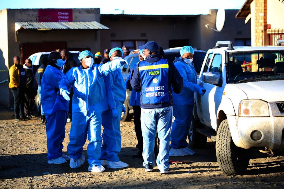 epa10034992 South African Police Forces (SAPS) and forensics experts work at the scene where an estimated 20 young people died in Enyobeni Tavern in East London, South Africa, 26 June 2022. The cause of death of the youngsters is yet to be established as 20 people died and 3 others have been hospitalized after an apparent party occurred overnight at the tavern. EPA/STR