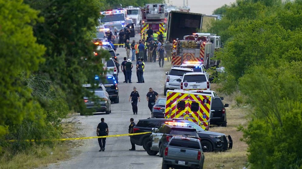 Police work the scene where dozens of people were found dead in a semitrailer in a remote area in southwestern San Antonio, Monday, June 27, 2022. (AP Photo/Eric Gay)