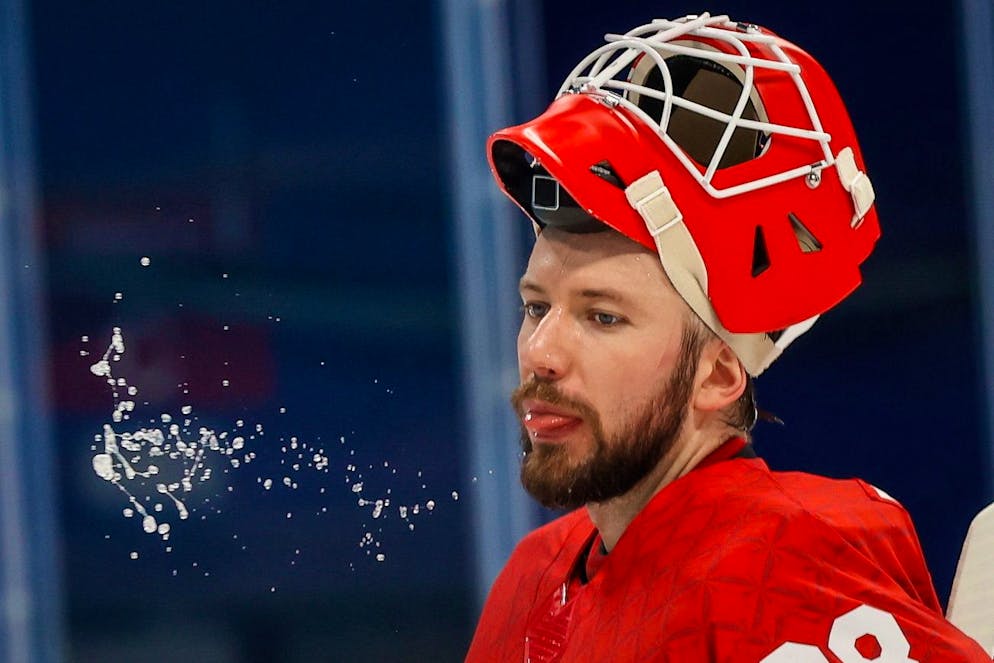 epa09761356 Goalkeeper Ivan Fedotov of Russia spits water during the Men's Ice Hockey Play-offs Quarterfinals match between the Russian Olympic Committee and Denmark at the Beijing 2022 Olympic Games, Beijing, China, 16 February 2022. EPA/MARK CRISTINO