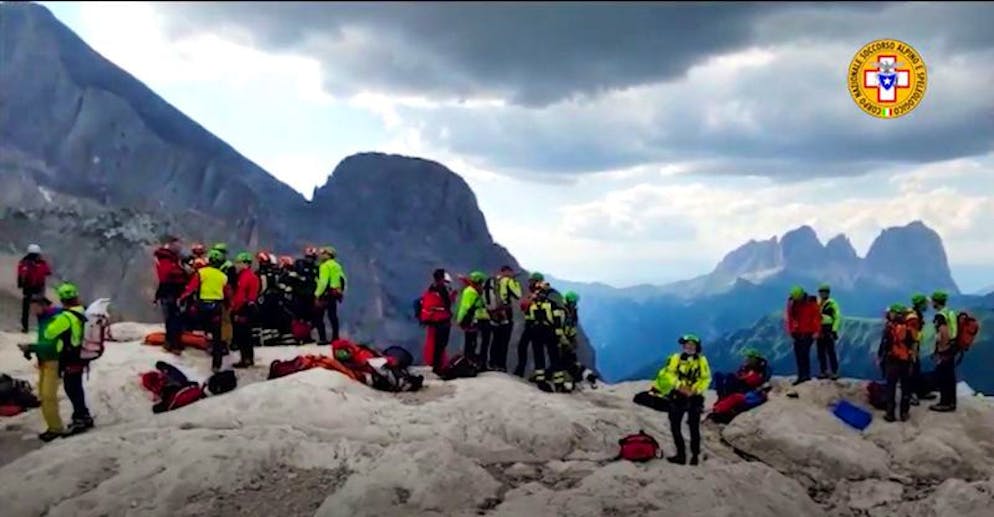 HANDOUT - 03.07.2022, Italien, Marmolata: Das Handout zeigt Menschen nahe des Gletscherruchs in den Dolomiten. Bei einem massiven Gletscherbruch in Norditalien sind mindestens fünf Menschen getötet und acht weitere zum Teil schwer verletzt worden. Foto: --/Corpo Nazionale Soccorso Alpino e Speleologico/dpa - ACHTUNG: Nur zur redaktionellen Verwendung im Zusammenhang mit der aktuellen Berichterstattung und nur mit vollständiger Nennung des vorstehenden Credits +++ dpa-Bildfunk +++
