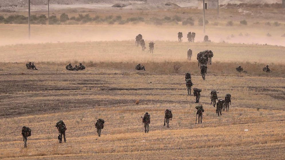 In this Monday, Oct.14, 2019 photo made available Tuesday, Oct. 15, 2019, Turkey's forces advance towards Manbij, Syria. U.S. military spokesman says U.S. forces have left Kurdish-held town of Manbij, part of withdrawal from northeast Syria. (Ugur Can/DHA via AP)