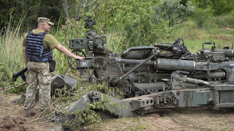 A Ukrainian soldier stands at a U.S.-supplied M777 howitzer in Ukraine's eastern Donetsk region Saturday, June 18, 2022. (AP Photo/Efrem Lukatsky)