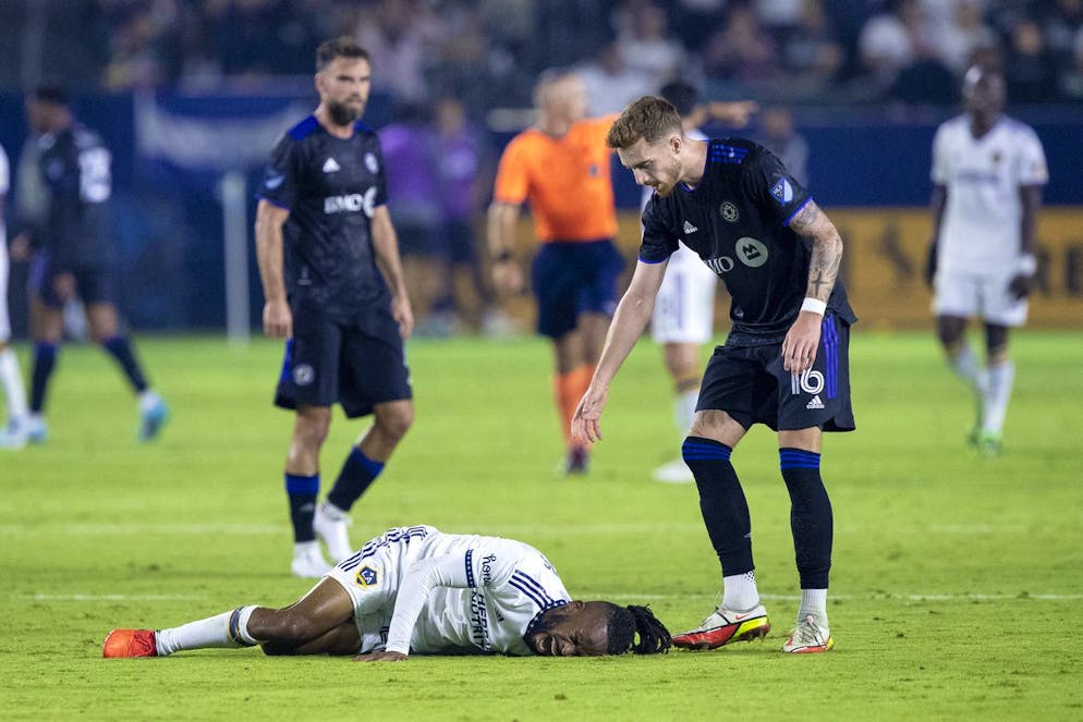 CF Montreal defender Joel Waterman, right, checks on LA Galaxy forward Raheem Edwards, below left, after Edwards got fouled during the second half of an MLS soccer match in Carson, Calif., Monday, July 4, 2022. (AP Photo/Alex Gallardo)