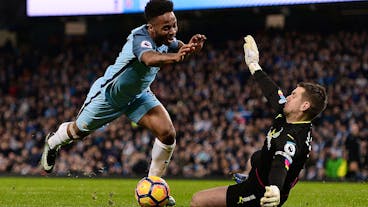 Burnley's English goalkeeper Tom Heaton (R) dives to save a shot from Manchester City's English midfielder Raheem Sterling during the English Premier League football match between Manchester City and Burnley at the Etihad Stadium in Manchester, north west England, on January 2, 2017. / AFP / Oli SCARFF / RESTRICTED TO EDITORIAL USE. No use with unauthorized audio, video, data, fixture lists, club/league logos or 'live' services. Online in-match use limited to 75 images, no video emulation. No use in betting, games or single club/league/player publications.  /         (Photo credit should read OLI SCARFF/AFP via Getty Images)