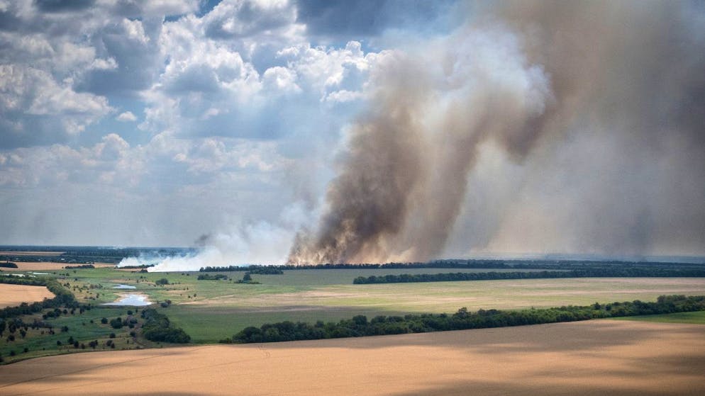 FILE - Smoke rises from the front lines of heavy fighting between Ukrainian and Russian troops, in farmer's fields in the foreground, in Dnipropetrovsk region, Ukraine, Monday, July 4, 2022. Military officials from Russia and Ukraine look at the United Nations, which exports banned Ukrainian grain to world markets via the Black Sea. A meeting was held in Istanbul to discuss the project.  Russia's invasion and war halted production and exports of Ukraine, one of the world's largest exporters of wheat, corn and sunflower oil.  (AP Photo/Efrem Lukatsky)