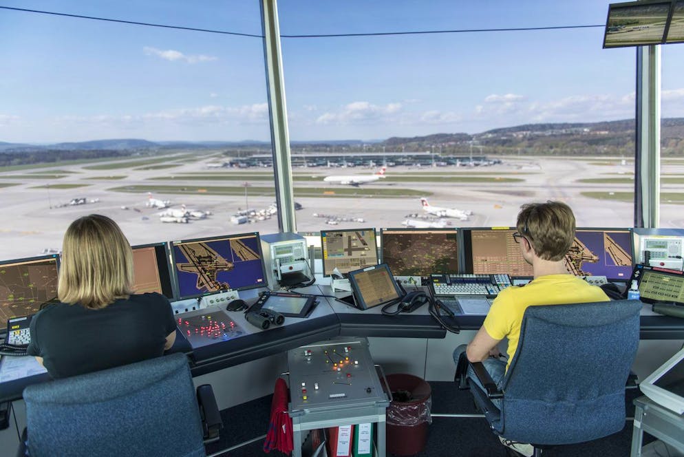 A Skyguide Employee Controls The Monitor And A View Of The Airspace On The Skyguide In The Tower At Zurich Kloten Airport, Pictured 10 April 2014.  In The Tower Of Zurich Airport, Skyguide Air Traffic Controllers Supervise The Roll Maneuvers, Take-Off And Landing And Traffic In The Immediate Vicinity Of Zurich Airport In The Control Zone With A Radius Of Approximately 20 Km Around The Airport.  (Keystone/Christian Beutler) Skyguide Employees Working In The Tower Of Zurich Airport In Switzerland, April 10, 2014.  Tower Air Traffic Controllers Oversee Taxiing Maneuvers, Takeoff And Landing And Monitor Traffic In The Immediate Vicinity Of The Airport, I.e. A Control Zone Of Approximately 20 Km Around The Airport.  (Keystone/Christian Beutler)