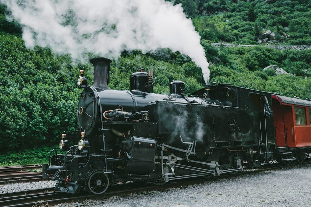 Old-fashioned steam train in Swiss Alps in summer