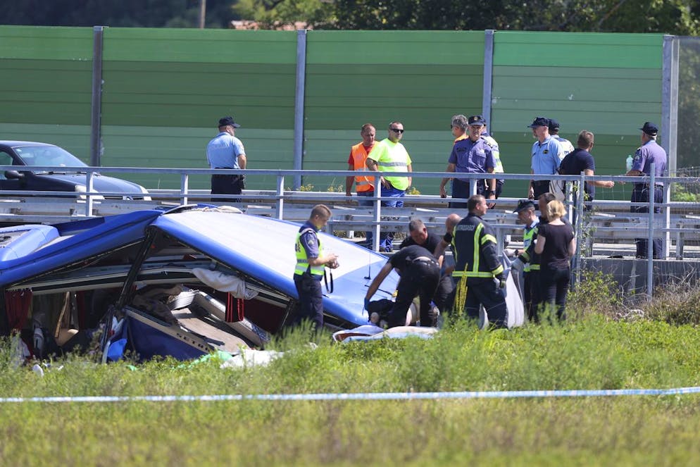 Rescuers remove a body from the wreckage of a bus at the crash scene in Podvorec, near Zagreb, Croatia, Saturday, Aug. 6, 2022. A bus with Polish license plates has skidded from a highway in northern Croatia, and police say more than 10 people were killed. CroatiaâÄ™s state HRT television reported that several more people were injured, many seriously. (AP Photo)