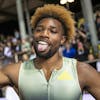 Noah Lyles of the United States, celebrates after winning the 200m Men holding up a sheet of paper with the words God's Son written on it, during the Athletissima IAAF Diamond League international athletics meeting in the Stade Olympique de la Pontaise in Lausanne, Switzerland, Friday, August 26, 2022. (KEYSTONE/Laurent Gillieron)