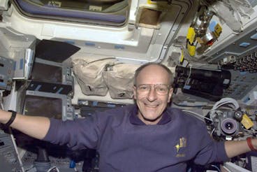 Swiss astronaut Claude Nicollier is seen aboard the space shuttle Discovery on Wednesday, December 3.  22, 1999. Discovery's main mechanics are out again Thursday, working amid floating cables and connectors, and replacing the old computer at the Hubble Space Telescope with a newer model.  (AP Photo/HO)