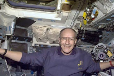 Swiss astronaut Claude Nicollier is seen aboard the space shuttle Discovery on Wednesday, December 3. 22, 1999. Discovery's main mechanics are out again Thursday, working amid floating cables and connectors, and replacing the old computer at the Hubble Space Telescope with a newer model. (AP Photo/HO)