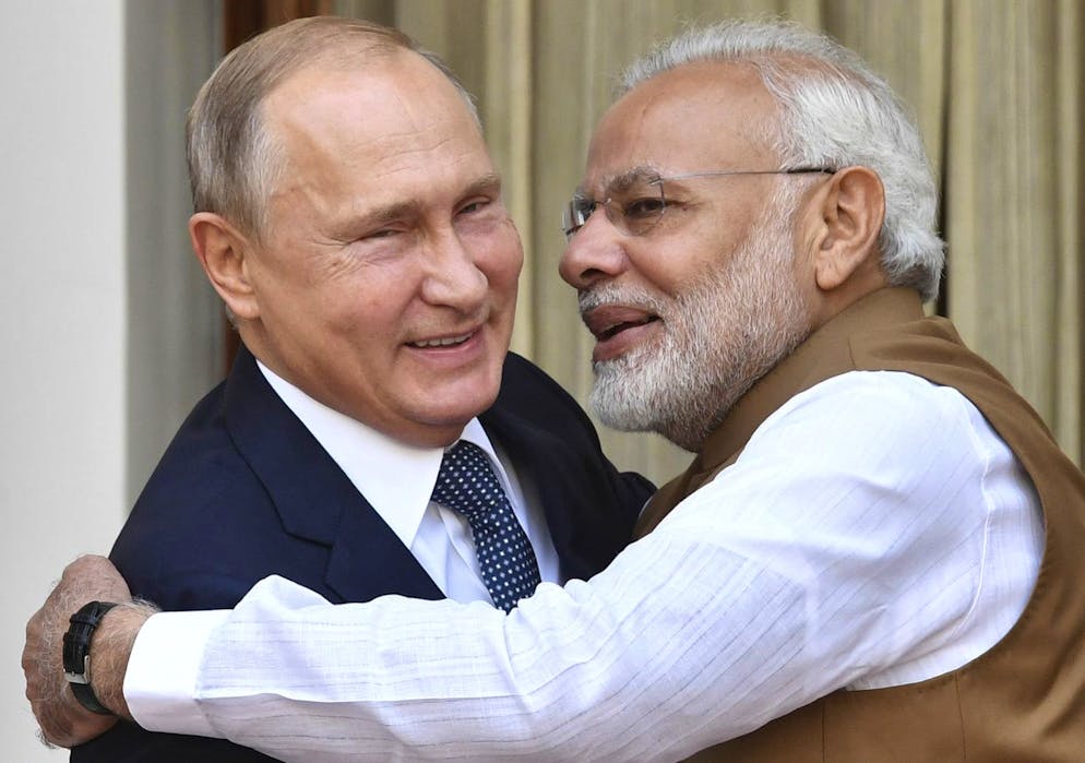 Indian Prime Minister Narendra Modi, right, hugs Russian President Vladimir Putin before their meeting in New Delhi, India, Friday, Oct. 5, 2018. Putin arrived in India on Thursday for a two-day visit during which India is expected to sign a $5 billion deal to buy Russian S-400 air defense systems despite a new US law ordering sanctions on any country trading with Russia's defense and intelligence sectors. (Yuri Kadobnov/Pool Photo via AP)