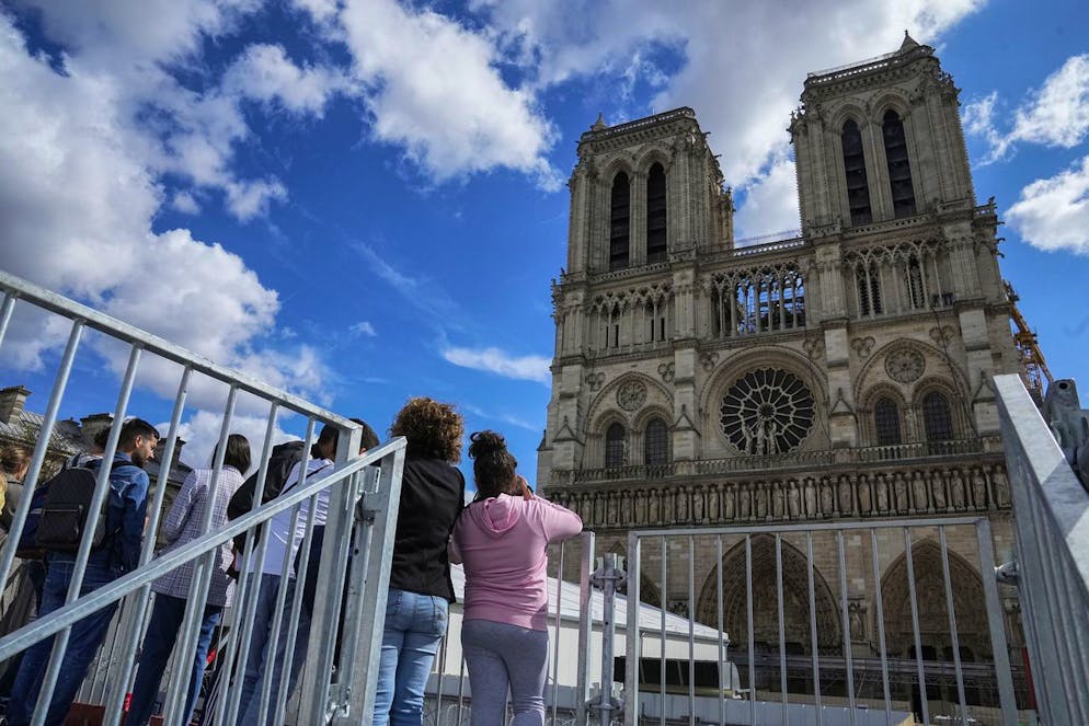 People look closely at Notre Dame Cathedral as they tour the reconstruction site during Heritage Day in Paris, Saturday, Sept. 17, 2022. (AP Photo/Michel Euler)