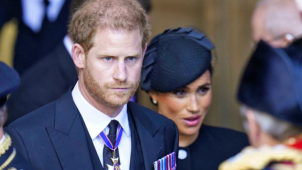 Prince Harry and his wife Meghan leave Westminster Hall in the Houses of Parliament in London on September 14, 2022, where the Queen's coffin is laid out. 