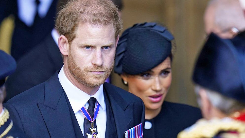 Prince Harry and his wife Meghan leave Westminster Hall in the Houses of Parliament in London on September 14, 2022, where the Queen's coffin is laid out.