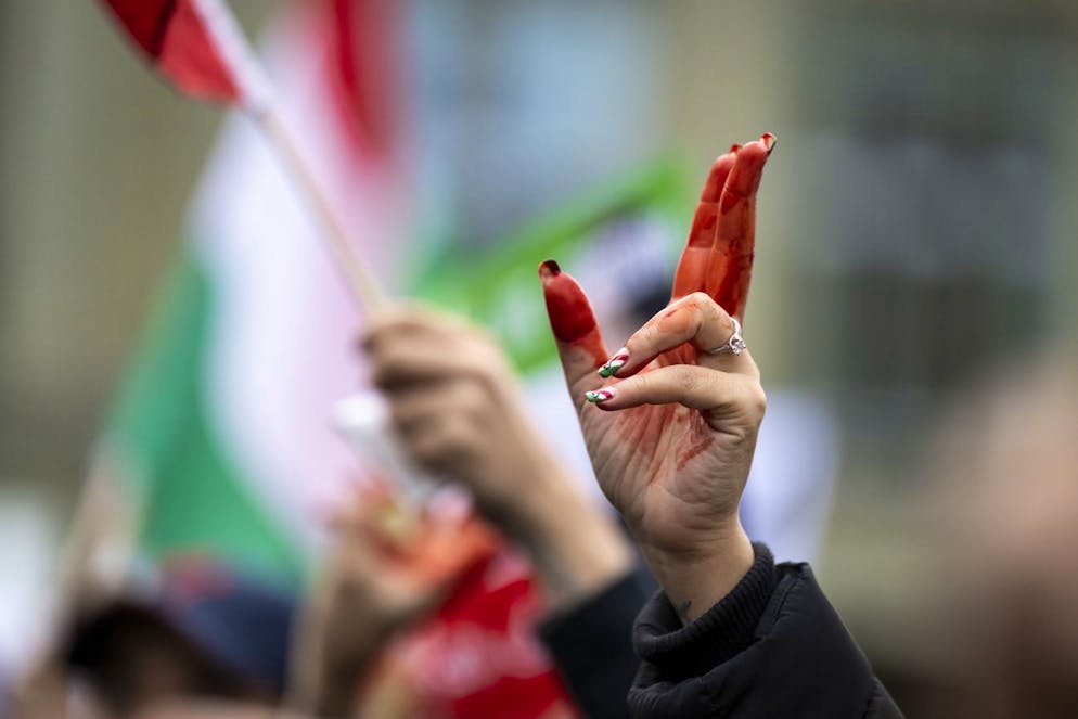 A woman's hand with red paint pictured during a freedom rally for Iranian Women, on the Federal Square (Bundesplatz) in Bern, Switzerland, on Saturday, November 5, 2022. After the death of Mahsa Amini the Iranian people, especially women and youth, are taking to the streets to protest against the cruel treatment of the population. The demonstrators in hundreds of cities are facing repression from the government authorities. For several weeks, the protesters have been demanding that the government respect the most basic human rights. (KEYSTONE/Anthony Anex)
