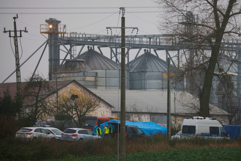 Police officers work outside a grain depot where, according to the Polish government, an explosion of a Russian-made missile killed two people in Przewodow, Poland, Wednesday, Nov. 16, 2022. Poland said Wednesday that a Russian-made missile fell in the country’s east, killing two people, though U.S. President Joe Biden said it was 
