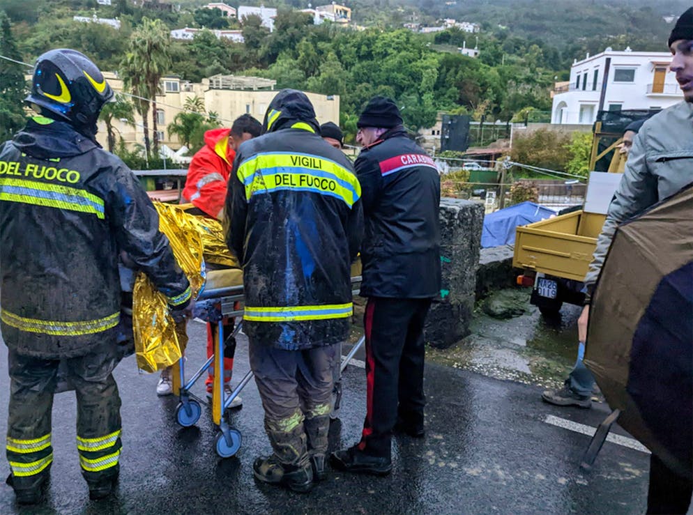 epa10329613 A man injured by the landslide is rescued by firefighters in Casamicciola, Ischia Island, Southern Italy, 26 November 2022. Thirteen people went missing on 26 November after heavy rains caused a landslide on the Italian island of Ischia.  EPA/ANSA ITALY OUT. BEST QUALITY AVAILABE.