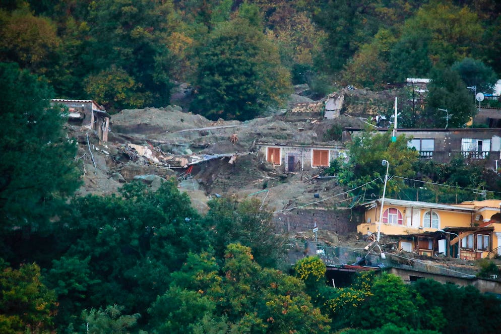 A view of flooded and mud covered houses are seen after heavy rainfall triggered landslides that collapsed buildings and left as many as 12 people missing, in Casamicciola, on the southern Italian island of Ischia, Saturday, Nov. 26, 2022. Firefighters are working on rescue efforts as reinforcements are being sent from nearby Naples, but are encountering difficulties in reaching the island either by motorboat or helicopter due to the weather. (AP Photo/Salvatore Laporta)