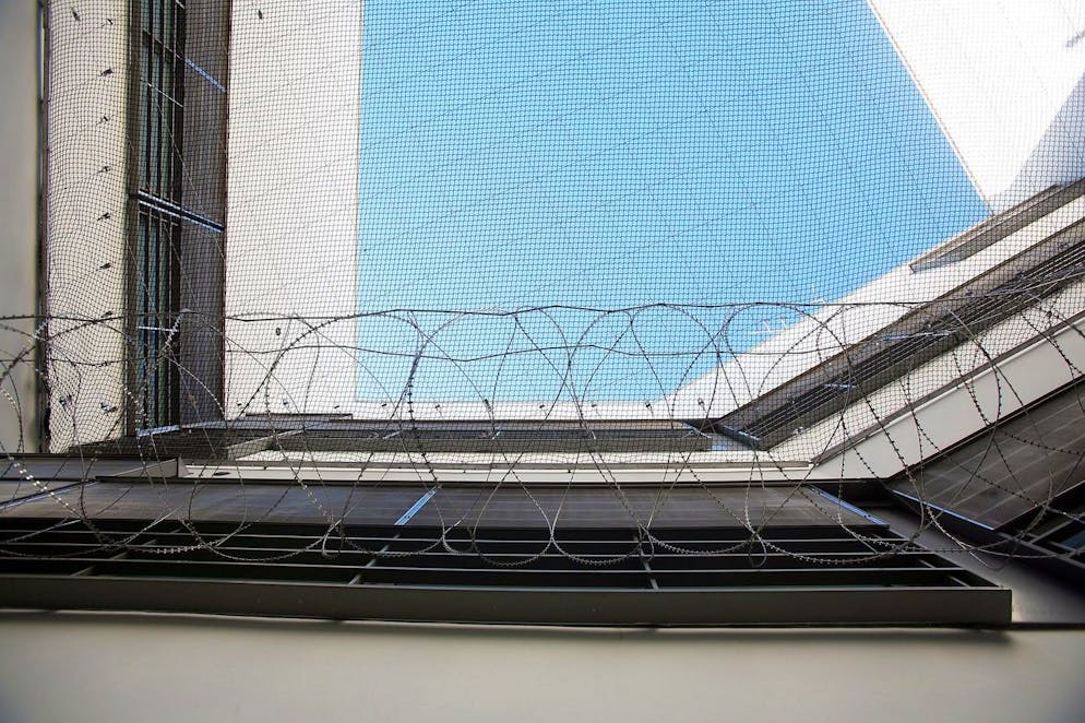 Stacheldraht und Sicherheitsnetze über einen Spazierhof des Basler Gefängnis Waaghof in Basel.