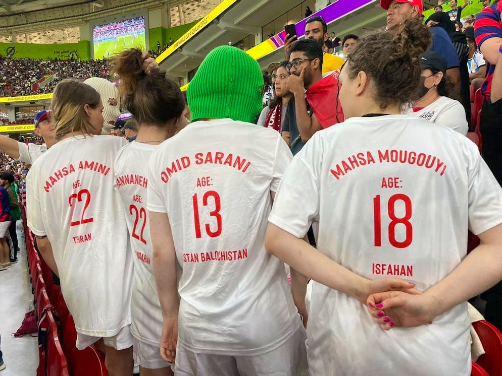 A group of young women wearing colorful balaclavas who identified themselves as members of the Pussy Riot collective in the stands during the World Cup group B soccer match between Iran and the United States at the Al Thumama Stadium in Doha, Qatar, Tuesday, Nov. 29, 2022. (AP Photo/Ciaran Fahey)