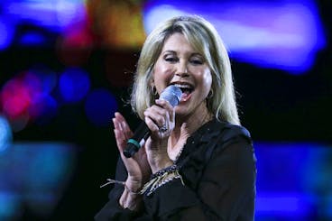 FILE - In this Feb. 23, 2017, file photo, Olivia Newton-John performs during the Vià±a del Mar International Song Festival at the Quinta Vergara in Vià±a del Mar, Chile. Newton-John said she has been diagnosed with cancer for the third time in three decades. The four-time Grammy winner, who will turn 70 on Sept. 26, told Australian news program âÄœSunday NightâÄ doctors found a tumor in her lower back in 2017. (AP Photo/Esteban Felix, File)