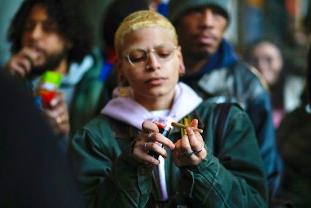 It's Legal: First Cannabis Shop Opens in NYC - Gallery.  A woman waits outside the first legal cannabis store in New York State to open on December 29, 2022 in New York City.