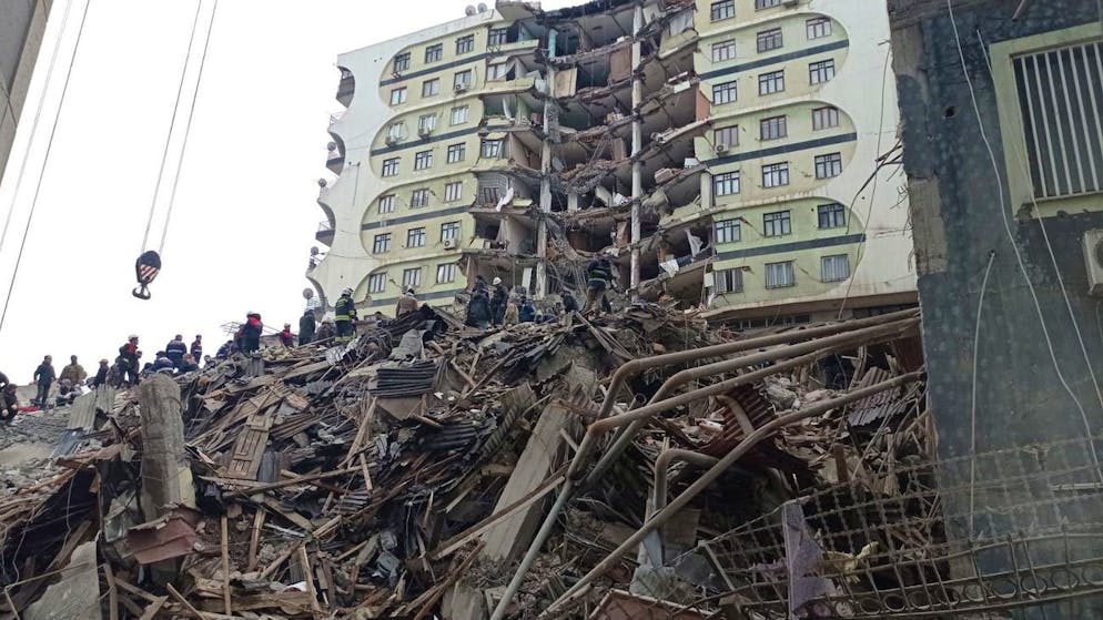 Des personnes et du personnel d'urgence recherchent des victimes sur le site d'un bâtiment effondré après un puissant tremblement de terre à Diyarbakir, au sud-est de la Turquie, le 06 février 2023.