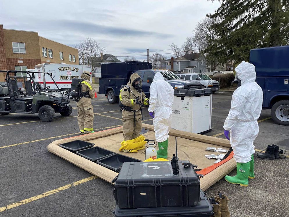 This photo provided by the Ohio National Guard, ONG 52nd Civil Support Team members prepare to enter an incident area to assess remaining hazards with a lightweight inflatable decontamination system (LIDS) in East Palestine, Ohio, Tuesday, Feb. 7, 2023. Authorities say air monitoring hasn't detected dangerous levels of fumes in communities where crews released and burned toxic chemicals from a derailed train. But they said Tuesday that Ohio and Pennsylvania residents living close to the wreckage still aren't being allowed in their homes.(Ohio National Guard via AP)