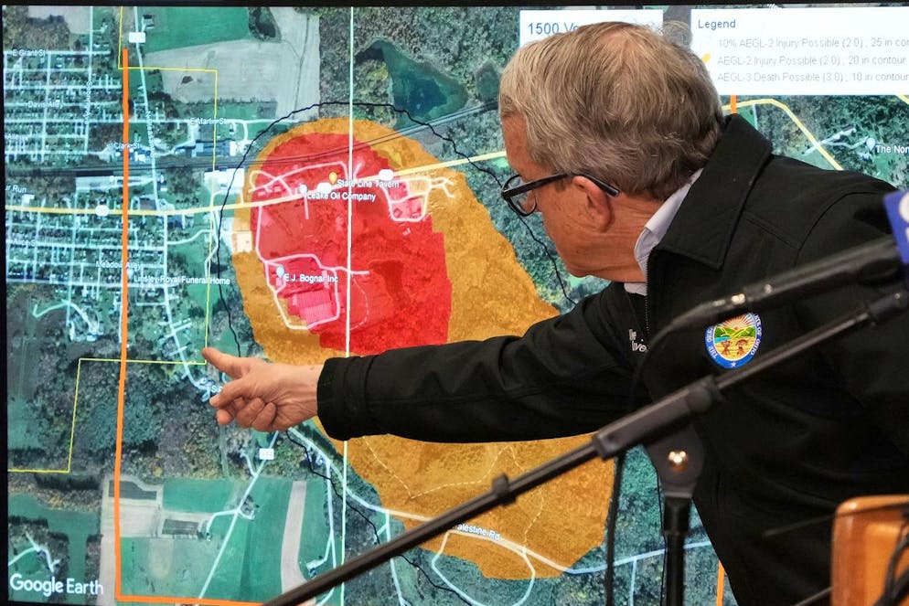 Ohio Governor Mike DeWine points to a map of East Palestine, Ohio that indicates the area that has been evacuated as a result of Norfolk and Southern train derailment, after touring the site, Monday, Feb. 6, 2023, in East Palestine, Ohio. (AP Photo/Gene J. Puskar)