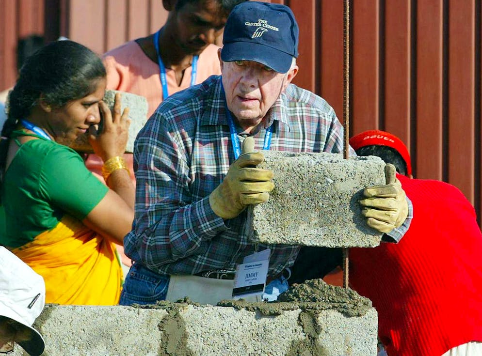 Former US President Jimmy Carter builds a house as part of the 23rd Jimmy Carter project in Patan Village, 100 kilometers (63 miles) south east of Mumbai, India, Monday, Oct. 30, 2006. 23rd Jimmy Carter Work Project will build 100 homes in a week for the underprivileged section of the society. (AP Photo/Rajesh Nirgude)