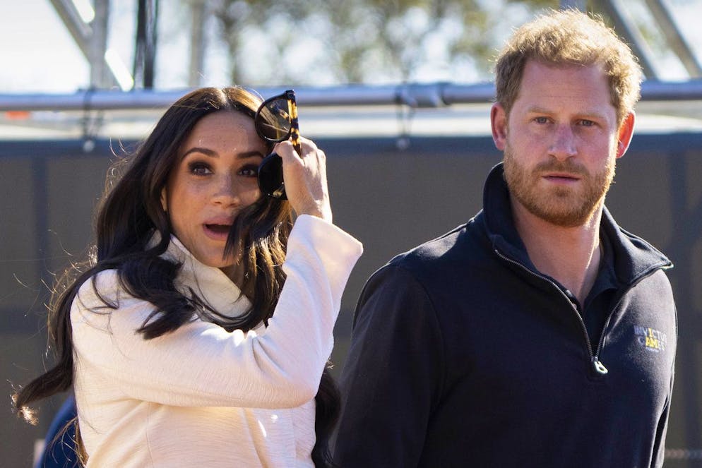 FILE - Prince Harry and Meghan Markle, Duke and Duchess of Sussex visit the track and field event at the Invictus Games in The Hague, Netherlands, Sunday, April 17, 2022. Prince Harry and his wife, Meghan, have been asked to vacate their home in Britain. Frogmore Cottage, located on the grounds of Windsor Castle west of London, had been intended as the couple's main residence before they gave up royal duties and moved to Southern California. (AP Photo/Peter Dejong, File)