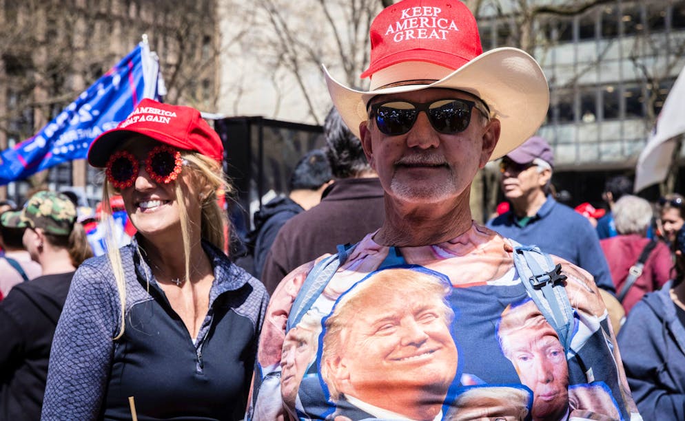 A supporter wearing a t-shirt with Former President Donald Trump's face on it attends a protest held in Collect Pond Park across the street from the Manhattan District Attorney's office in New York on Tuesday, April 4, 2023. (AP Photo/Stefan Jeremiah)