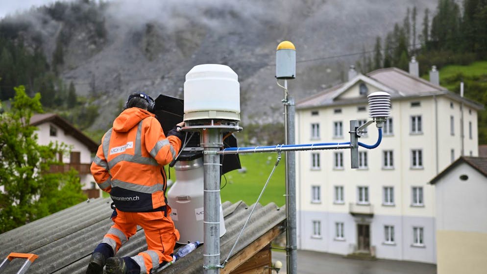 Ein Mann arbeitet am 10. Mai 2023 an einem Messgerät, das den Hang in Brienz überwacht