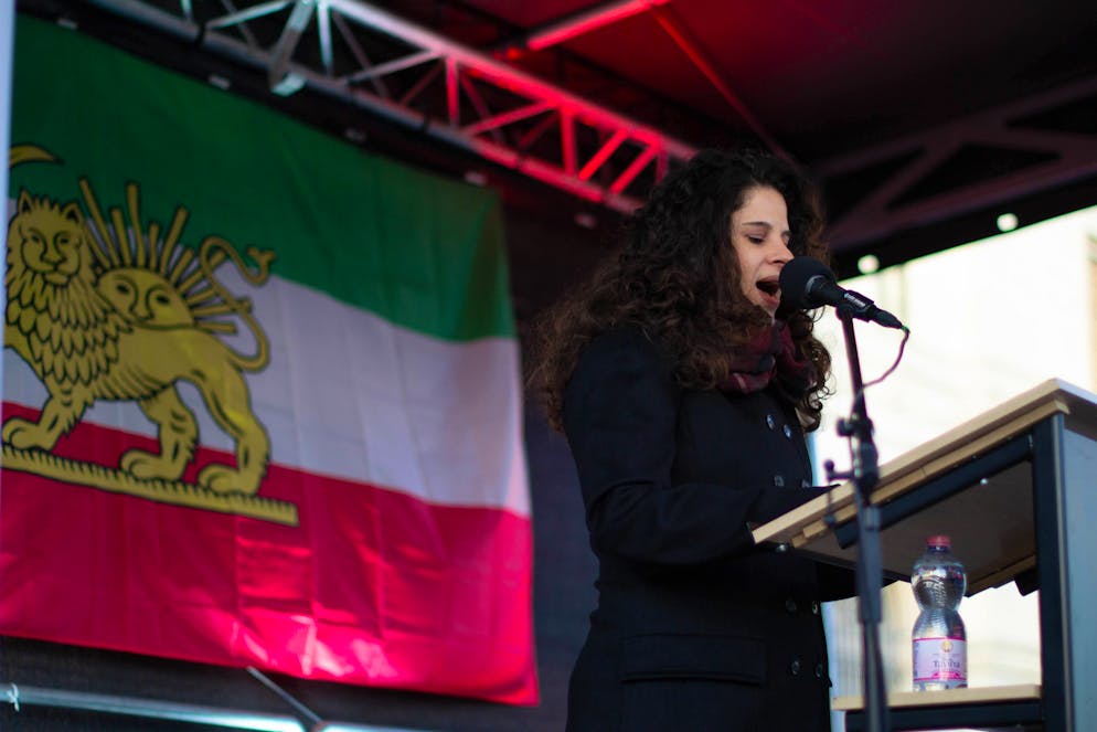 Shiva Arbabi, Schweizer Stars singen Iran-Protestsong. Shiva Arbabi hält bei einer Demonstration eine Rede. Sie kann nicht nachvollziehen, warum Schweizer Radiostationen wie das SRF den Song nicht thematisieren. 