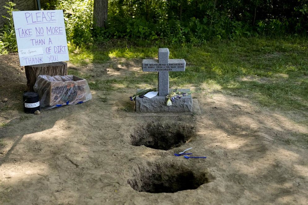 Sister Wilhelmina.  People pick up dirt from the grave of Sister Wilhelmina Lancaster at the Benedictine Abbey of Mary, Queen of the Apostles, Sunday, May 28, 2023, near Gower, Missouri.