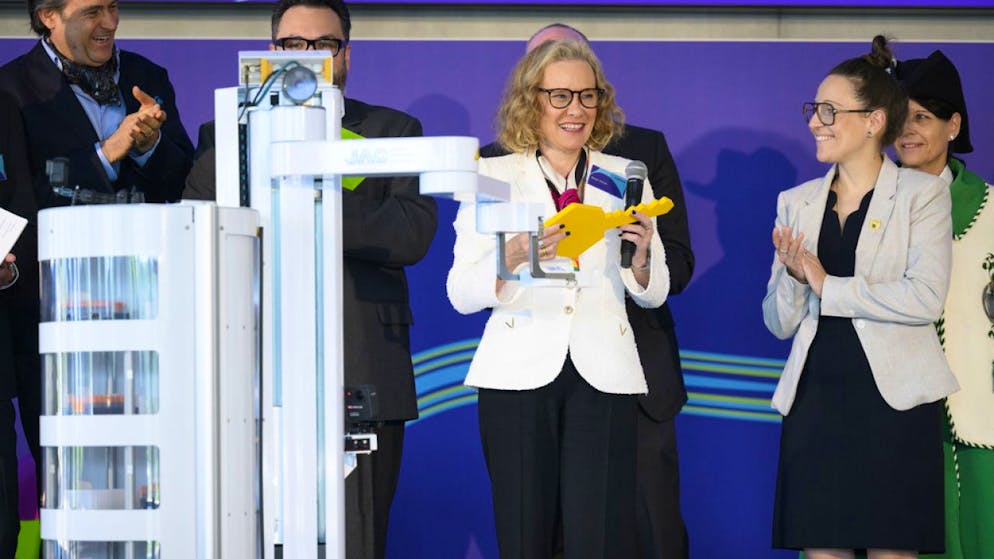 Merck inaugure son centre de Biotech à Corsier-sur-Vevey - Gallery. Un robot donne une clé symbolique à Belén Garijo, CEO du groupe Merck (à gauche) et à Séverine Evequoz (à droite), présidente du Grand Conseil vaudois.