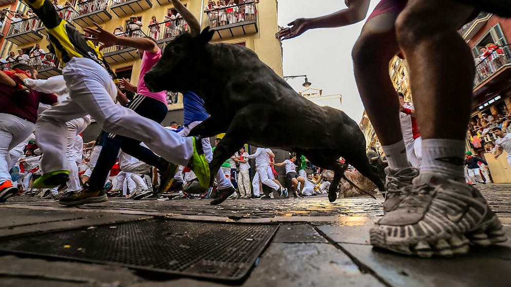 dpatopbilder - Männer treiben Kampfstiere von Jose Escolar Gil am zweiten Tag des Stiertreibens während des «Sanfermines»-Festes durch die Gassen des Ortes. Auch bei der zweiten Stierhatz während des diesjährigen «Sanfermines»-Festes sind am Samstagmorgen in Pamplona im Norden Spaniens mehrere Menschen verletzt worden. Foto: Alvaro Barrientos/AP